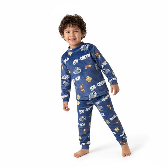 A young boy wearing a cozy blue Twinkles Tom and Jerry fleece pajama set with long sleeves and a mock-neck collar.
