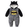 Twinkles Batman romper in grey and black plush fabric with a yellow logo and a hooded design featuring bat ears.