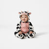Twinkles baby wearing a cozy black and white cow-patterned polar fleece jumpsuit with a hooded animal face