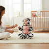 Twinkles baby wearing a cozy cow-themed polar fleece hooded bunting with pink front panel in a bright nursery
