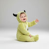 Twinkles baby wearing a light green polar fleece monster jumpsuit with a hooded design and black horns