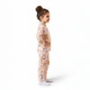 Twinkles hi bear pajama set in soft peach featuring cute teddy bear prints worn by a young girl in profile view