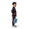 A young boy wearing a Twinkles black Lightning McQueen print pajama set, holding a blue Stitch plush toy.