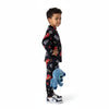 A young boy wearing a Twinkles black Lightning McQueen print pajama set, holding a blue Stitch plush toy.