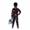 Twinkles boy wearing a black Lightning McQueen fleece pajama set with red car prints, holding a Stitch plush toy.