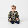 Twinkles baby wearing a soft olive green Mickey Mouse fleece pajama set with navy blue cuffs while sitting
