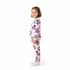 Young girl wearing a pink Twinkles Minnie Mouse pajama set with a cute character print on a white background