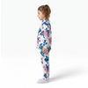 Twinkles thermal pajama set featuring Stitch and Angel print on a child standing in profile view.