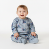 Twinkles baby wearing a soft grey Stitch character print long-sleeve pajama set with footed bottoms